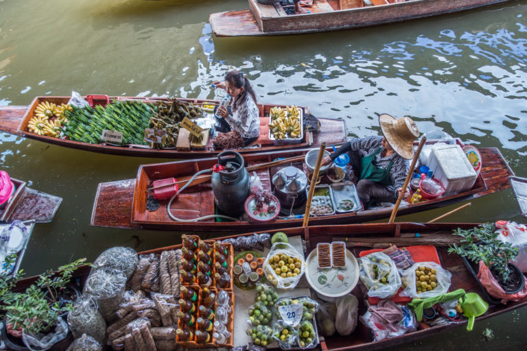 Selling food from their paddle boats